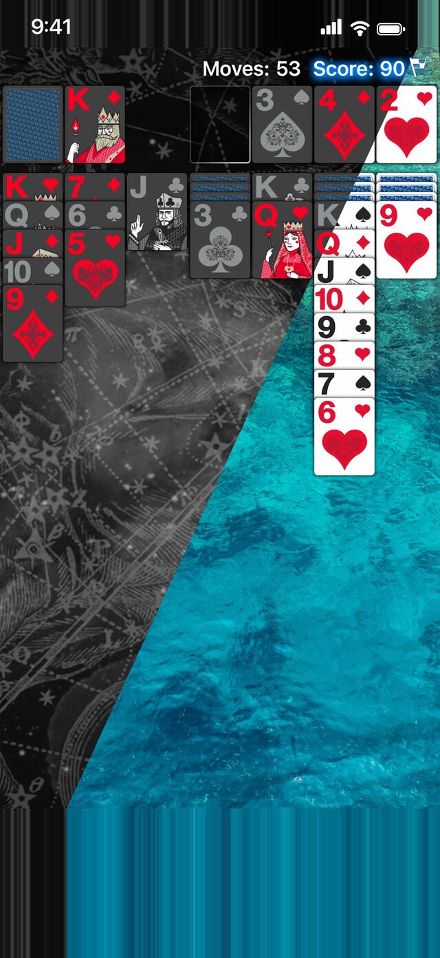 Real Solitaire Pro for iPhone: dark cards on a star chart beside light cards over ocean water.